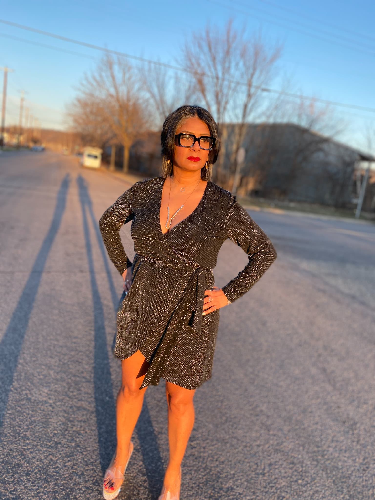 MzLeigh, Founder and CEO of I Am She LLC, standing confidently in the evening sunlight